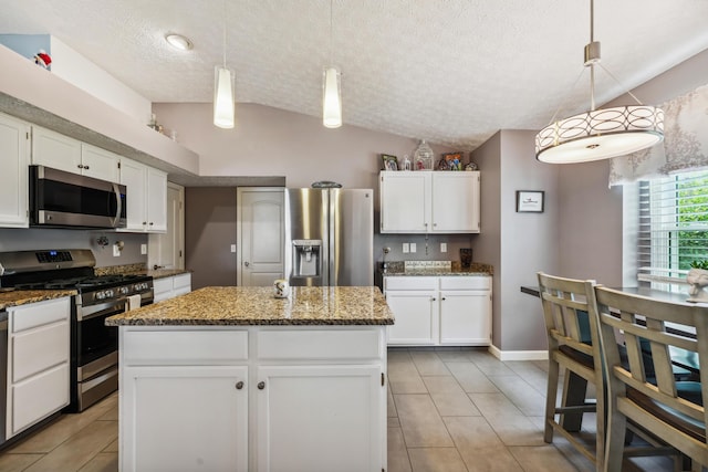 5718 Brook Hollow Dr, Hilliard, OH 43026 - kitchen with stainless steel appliances, light tile patterned floors, white cabinets, a textured ceiling, and stone counters