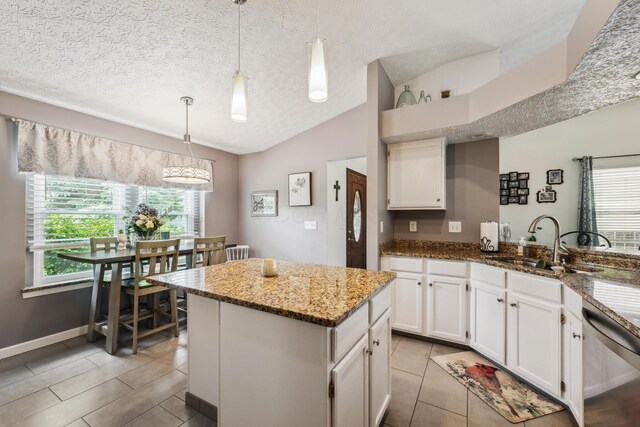 5718 Brook Hollow Dr, Hilliard, OH 43026 - kitchen featuring dishwasher, lofted ceiling, healthy amount of natural light, a sink, and white cabinets