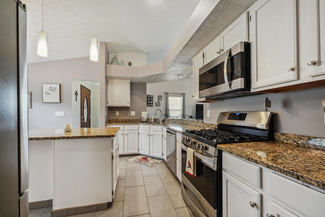 5718 Brook Hollow Dr, Hilliard, OH 43026 - kitchen with appliances with stainless steel finishes, lofted ceiling, a sink, white cabinets, and dark stone countertops
