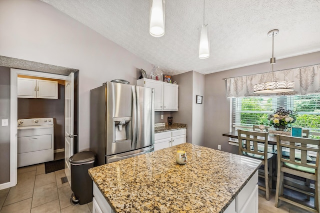 5718 Brook Hollow Dr, Hilliard, OH 43026 - kitchen with washer / dryer, stainless steel fridge, white cabinets, a textured ceiling, and hanging light fixtures