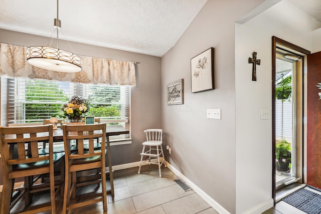 5718 Brook Hollow Dr, Hilliard, OH 43026 - dining area with baseboards, light tile patterned flooring, and a textured ceiling