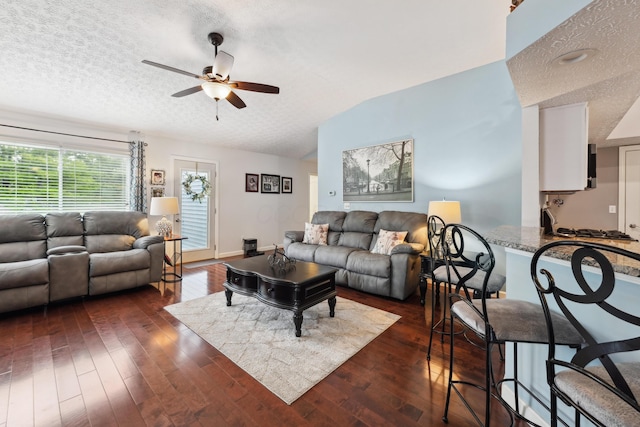 5718 Brook Hollow Dr, Hilliard, OH 43026 - living room with dark wood-type flooring, ceiling fan, vaulted ceiling, and a textured ceiling