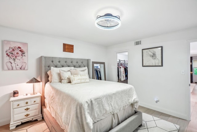 1450 Cliff Ct Unit 25, Columbus, OH 43204 - bedroom featuring a spacious closet, baseboards, a closet, and light wood finished floors