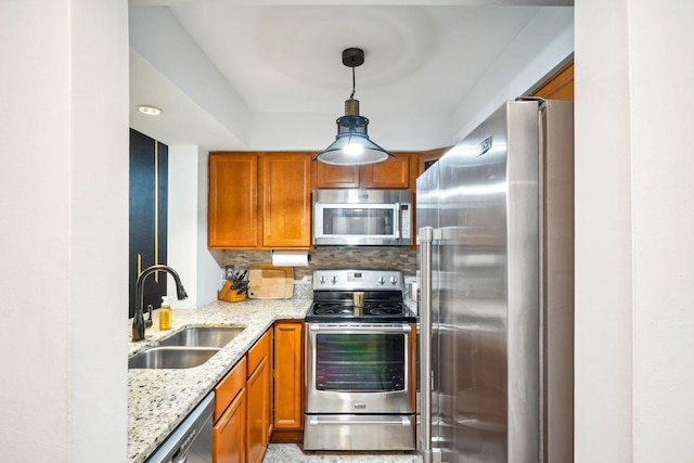 1450 Cliff Ct Unit 25, Columbus, OH 43204 - kitchen with stainless steel appliances, a sink, brown cabinetry, and light stone countertops