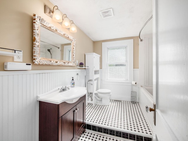 34 Columbus Ave, Delaware, OH 43015 - full bathroom with a wainscoted wall, vanity, toilet, tile patterned flooring, and tub / shower combination