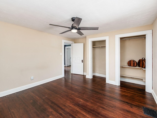 34 Columbus Ave, Delaware, OH 43015 - unfurnished bedroom featuring multiple closets, wood finished floors, baseboards, and ceiling fan