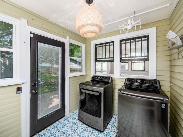 34 Columbus Ave, Delaware, OH 43015 - laundry area with independent washer and dryer, wood walls, and a chandelier