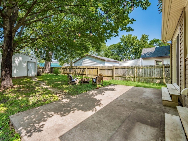 34 Columbus Ave, Delaware, OH 43015 - fenced backyard featuring a patio area and a fire pit