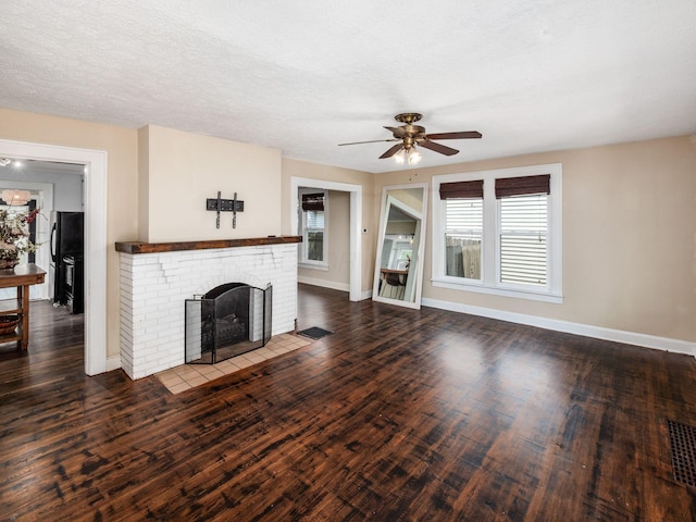 34 Columbus Ave, Delaware, OH 43015 - unfurnished living room featuring a ceiling fan, baseboards, wood finished floors, and a brick fireplace