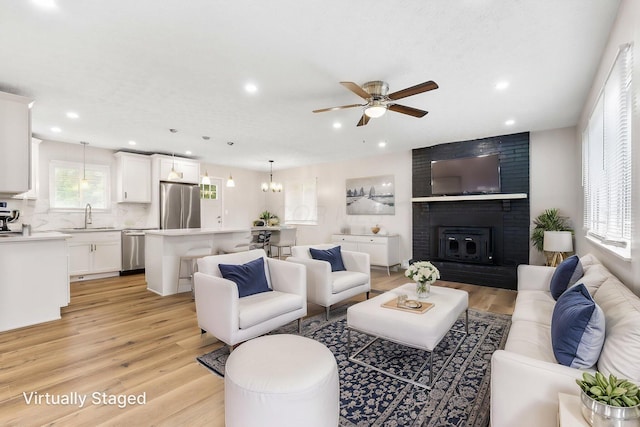 3998 Scioto Darby Creek Rd, Hilliard, OH 43026 - living room featuring a ceiling fan, light wood-style flooring, recessed lighting, and a fireplace