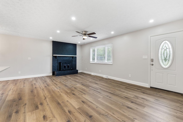 3998 Scioto Darby Creek Rd, Hilliard, OH 43026 - unfurnished living room with ceiling fan, recessed lighting, wood finished floors, baseboards, and a fireplace
