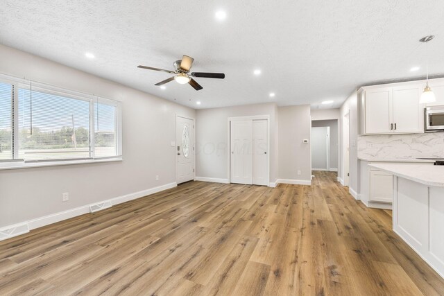 3998 Scioto Darby Creek Rd, Hilliard, OH 43026 - unfurnished living room featuring recessed lighting, a ceiling fan, light wood-style floors, baseboards, and a textured ceiling