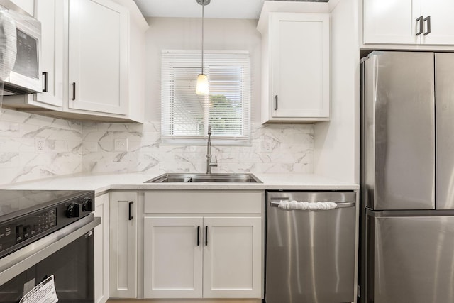 3998 Scioto Darby Creek Rd, Hilliard, OH 43026 - kitchen with appliances with stainless steel finishes, a sink, light countertops, and hanging light fixtures