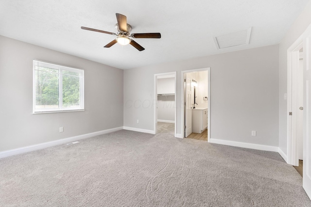 3998 Scioto Darby Creek Rd, Hilliard, OH 43026 - unfurnished bedroom featuring baseboards, a walk in closet, light colored carpet, attic access, and ensuite bathroom