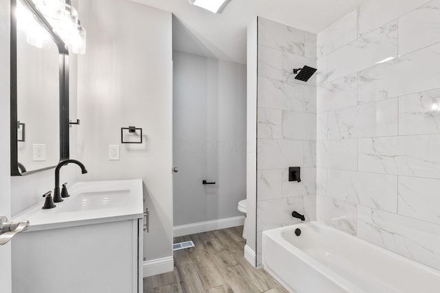 3998 Scioto Darby Creek Rd, Hilliard, OH 43026 - bathroom with vanity, toilet,  shower combination, wood finished floors, and baseboards