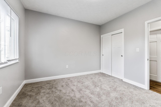 3998 Scioto Darby Creek Rd, Hilliard, OH 43026 - unfurnished bedroom with multiple windows, carpet floors, and baseboards