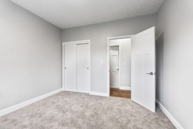 3998 Scioto Darby Creek Rd, Hilliard, OH 43026 - unfurnished bedroom with carpet, a closet, baseboards, and a textured ceiling