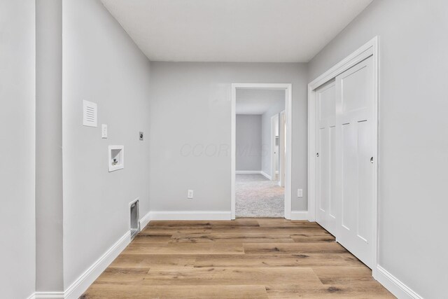 3998 Scioto Darby Creek Rd, Hilliard, OH 43026 - washroom featuring electric dryer hookup, washer hookup, light wood-style floors, and baseboards