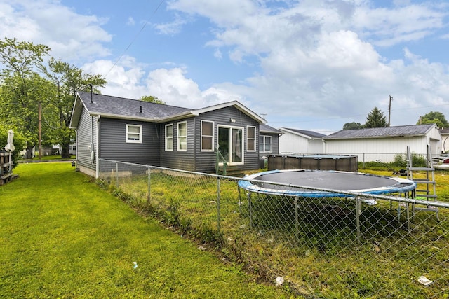 217 N Yencer St, Baltimore, OH 43105 - back of property featuring a trampoline and roof with shingles