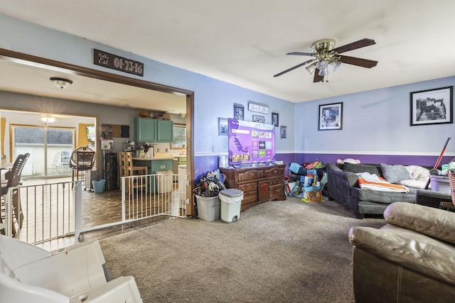 217 N Yencer St, Baltimore, OH 43105 - carpeted living room featuring a ceiling fan and a wainscoted wall