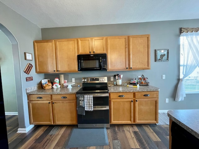 6231 Red Glare Dr Unit 287, Galloway, OH 43119 - kitchen with black microwave, range with two ovens, arched walkways, dark wood-style floors, and a textured ceiling
