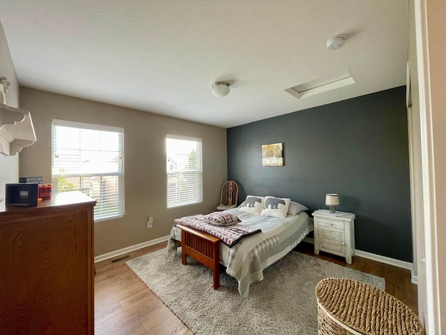 6231 Red Glare Dr Unit 287, Galloway, OH 43119 - bedroom featuring attic access, wood finished floors, and baseboards