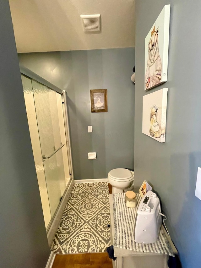 6231 Red Glare Dr Unit 287, Galloway, OH 43119 - bathroom featuring a stall shower, baseboards, and toilet