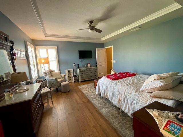 6231 Red Glare Dr Unit 287, Galloway, OH 43119 - bedroom featuring a raised ceiling, hardwood / wood-style floors, a ceiling fan, and crown molding