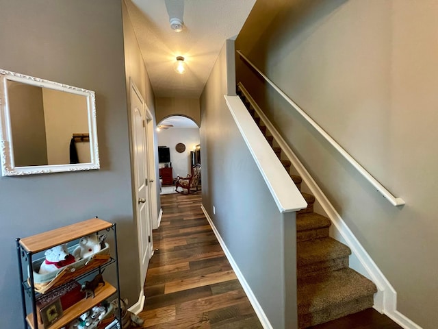 6231 Red Glare Dr Unit 287, Galloway, OH 43119 - corridor with arched walkways, dark wood-type flooring, stairway, and baseboards