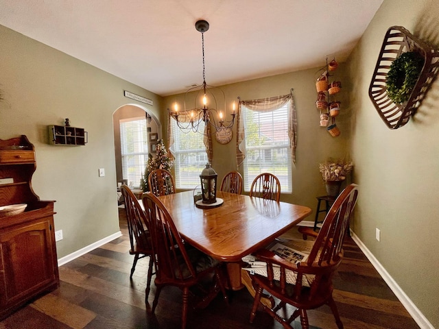 6231 Red Glare Dr Unit 287, Galloway, OH 43119 - dining space with arched walkways, dark wood-style floors, a chandelier, and baseboards