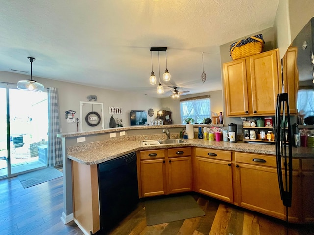 6231 Red Glare Dr Unit 287, Galloway, OH 43119 - kitchen with black dishwasher, a sink, dark wood-style floors, a peninsula, and a textured ceiling