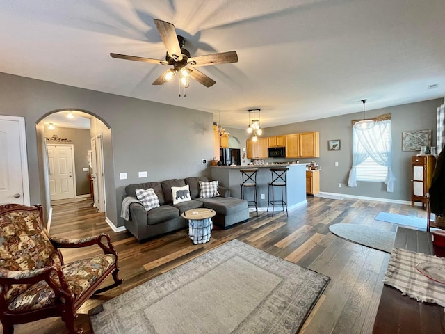 6231 Red Glare Dr Unit 287, Galloway, OH 43119 - living area featuring arched walkways, ceiling fan, dark wood-style flooring, and baseboards
