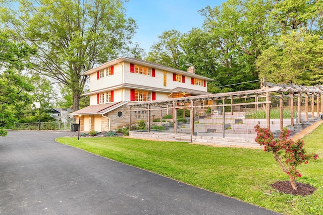 1117 E Vine St, Mount Vernon, OH 43050 - view of front of house with stone siding, a chimney, and asphalt driveway