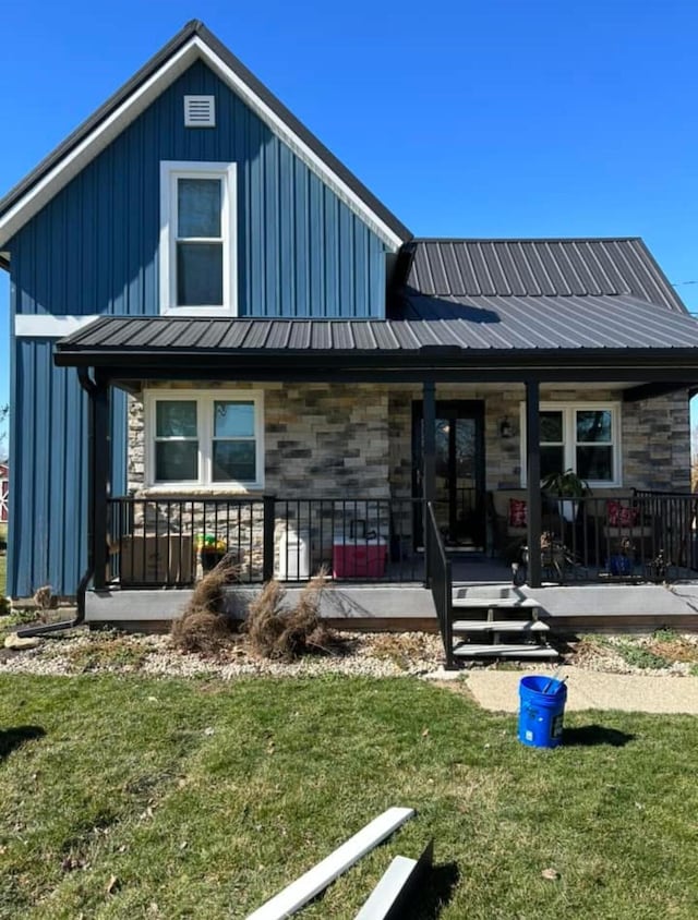 20770 Peoria Loop Rd, Raymond, OH 43067 - view of front facade with stone siding, covered porch, a front yard, and metal roof