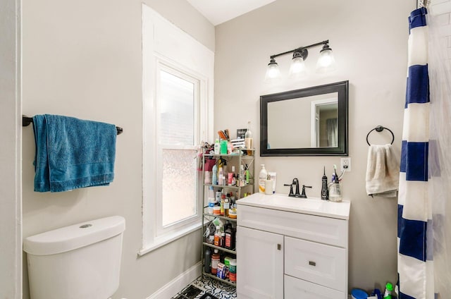 626-628 Wilson Ave, Columbus, OH 43205 - bathroom featuring vanity, toilet, baseboards, and plenty of natural light