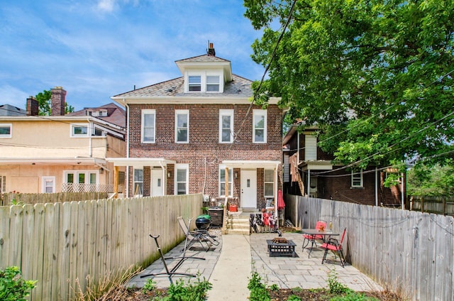 626-628 Wilson Ave, Columbus, OH 43205 - rear view of property featuring a fenced backyard, a high end roof, a patio area, and brick siding