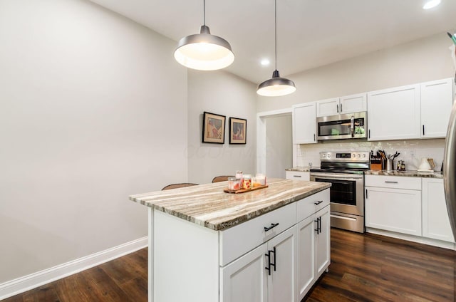 626-628 Wilson Ave, Columbus, OH 43205 - kitchen featuring appliances with stainless steel finishes, backsplash, dark wood finished floors, a kitchen island, and recessed lighting