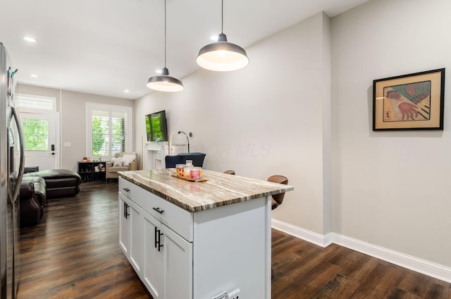 626-628 Wilson Ave, Columbus, OH 43205 - kitchen with dark wood-style flooring, white cabinets, decorative light fixtures, recessed lighting, and light stone countertops