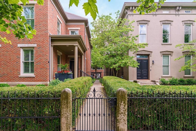 873 S Pearl St, Columbus, OH 43206 - italianate home featuring a gate, brick siding, and a fenced front yard