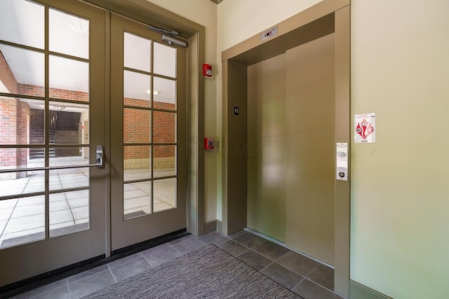 873 S Pearl St, Columbus, OH 43206 - doorway to outside with elevator and dark tile patterned flooring