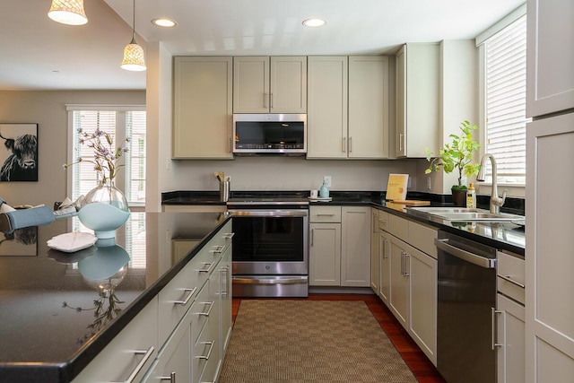 873 S Pearl St, Columbus, OH 43206 - kitchen featuring stainless steel appliances, a sink, dark wood-style flooring, recessed lighting, and hanging light fixtures