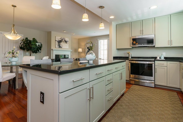 873 S Pearl St, Columbus, OH 43206 - kitchen with stainless steel appliances, dark countertops, dark wood-type flooring, hanging light fixtures, and recessed lighting