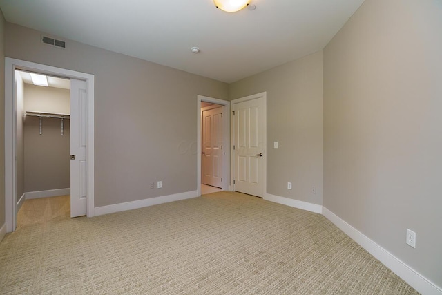 873 S Pearl St, Columbus, OH 43206 - unfurnished bedroom featuring baseboards, a spacious closet, and light colored carpet