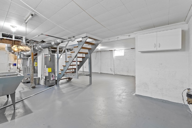 3091 Azelda St, Columbus, OH 43224 - below grade area featuring water heater, stairs, heating unit, and a sink