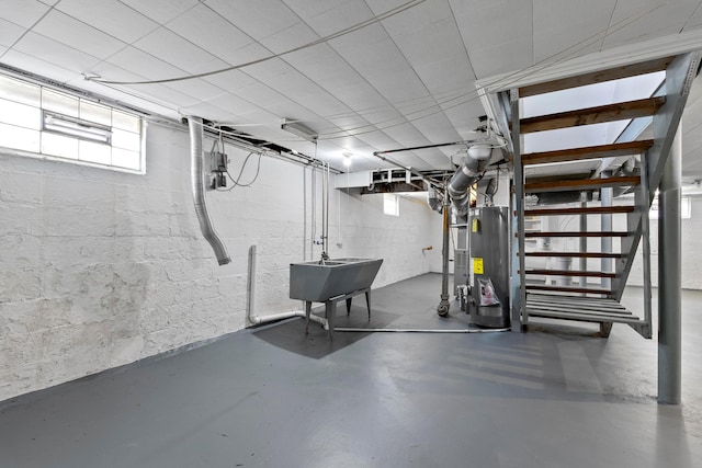 3091 Azelda St, Columbus, OH 43224 - below grade area featuring water heater, stairway, and a sink