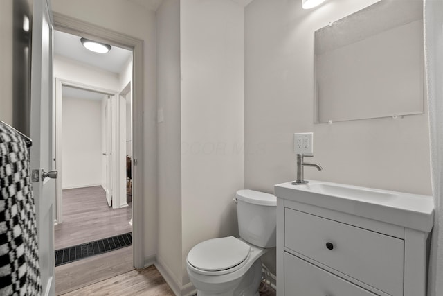 3091 Azelda St, Columbus, OH 43224 - bathroom featuring wood finished floors, vanity, toilet, and baseboards