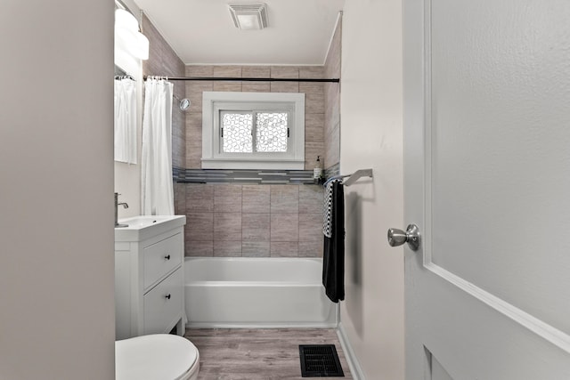 3091 Azelda St, Columbus, OH 43224 - bathroom featuring toilet, vanity, shower / tub combo with curtain, and wood finished floors
