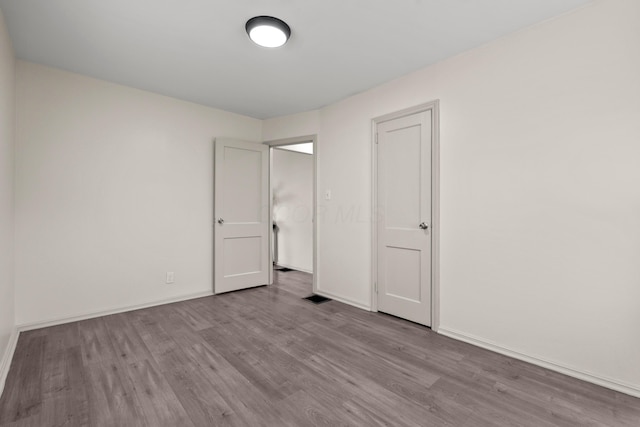 3091 Azelda St, Columbus, OH 43224 - unfurnished bedroom with wood finished floors and baseboards