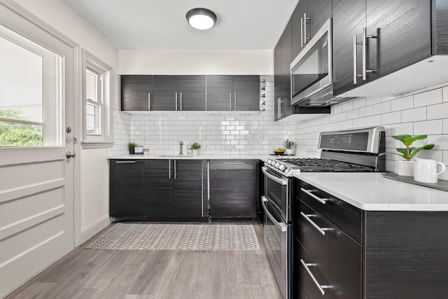 3091 Azelda St, Columbus, OH 43224 - kitchen featuring stainless steel appliances, modern cabinets, tasteful backsplash, and light countertops