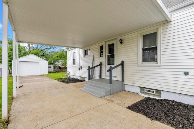 3091 Azelda St, Columbus, OH 43224 - view of patio / terrace featuring an outdoor structure, a carport, a detached garage, and concrete driveway